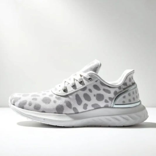 White running shoe with gray pattern on a white background