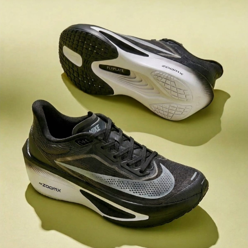 Black and gray running shoes with 'ZoomX' branding on a yellow background
