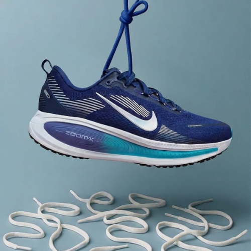 Blue running shoe with white laces on a light blue background