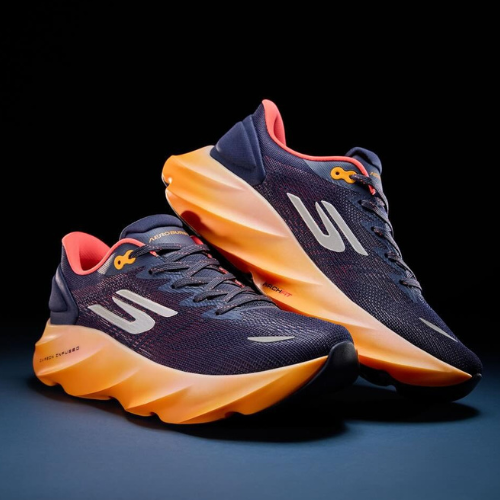 Navy and orange running shoes on a dark background