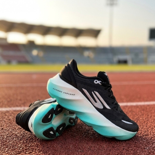 Black and teal running shoes on a track