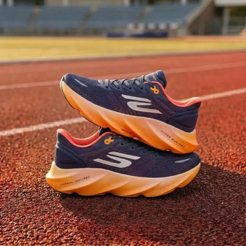 Navy and orange running shoes on a track
